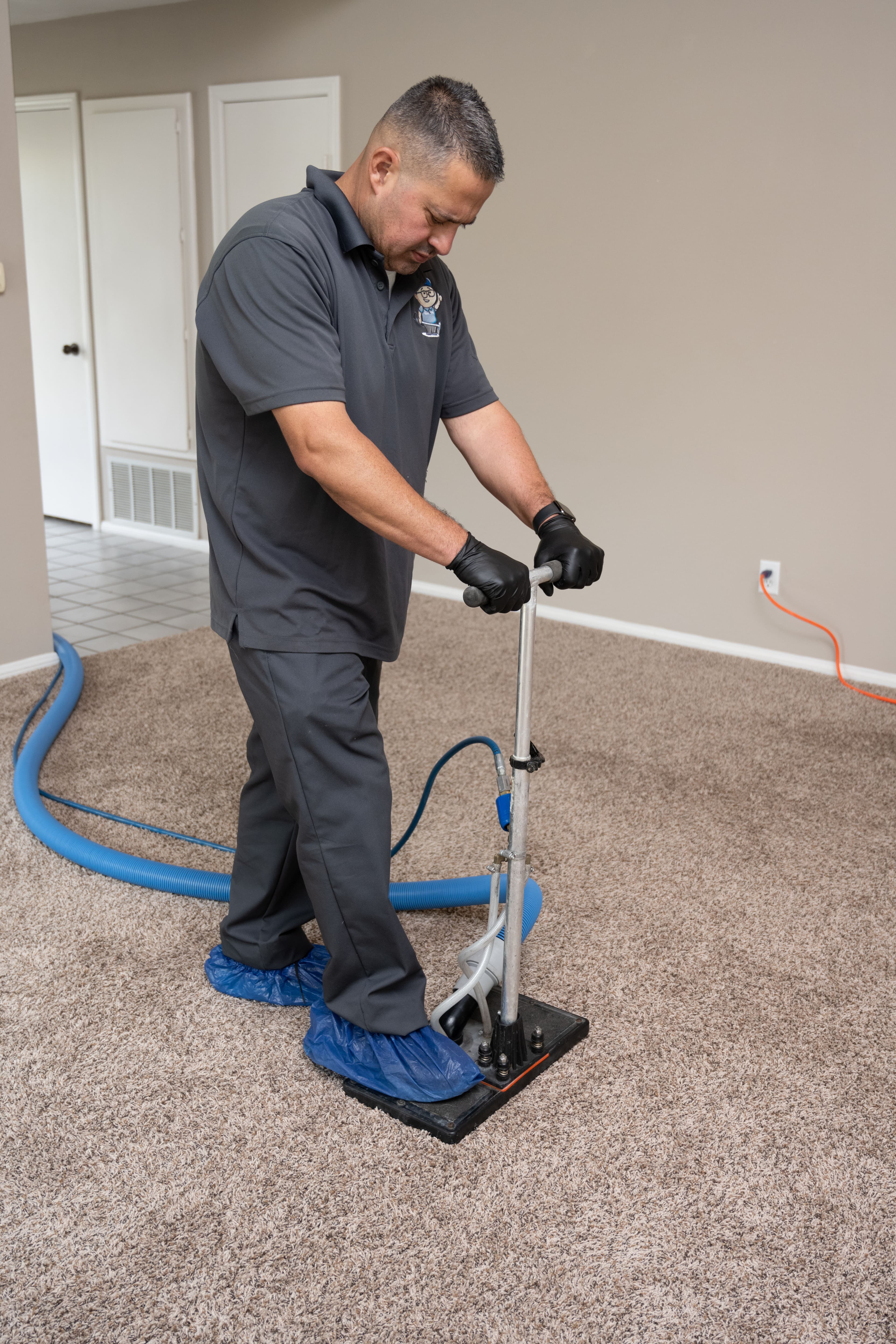 RestoreIQ technician extracting water from carpet